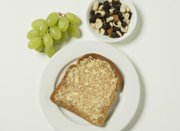 Photo of grapes with a slice of toast with lower fat spread