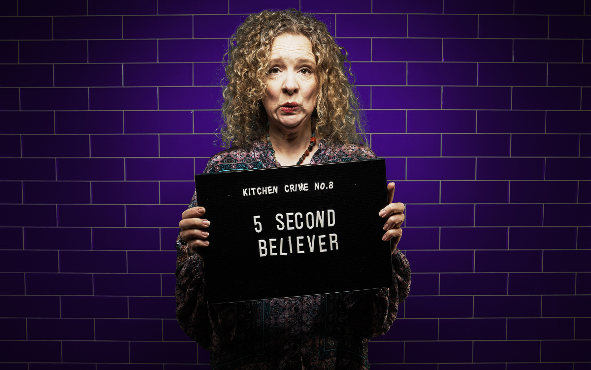 Woman holding mug shot board with words 5 second believer