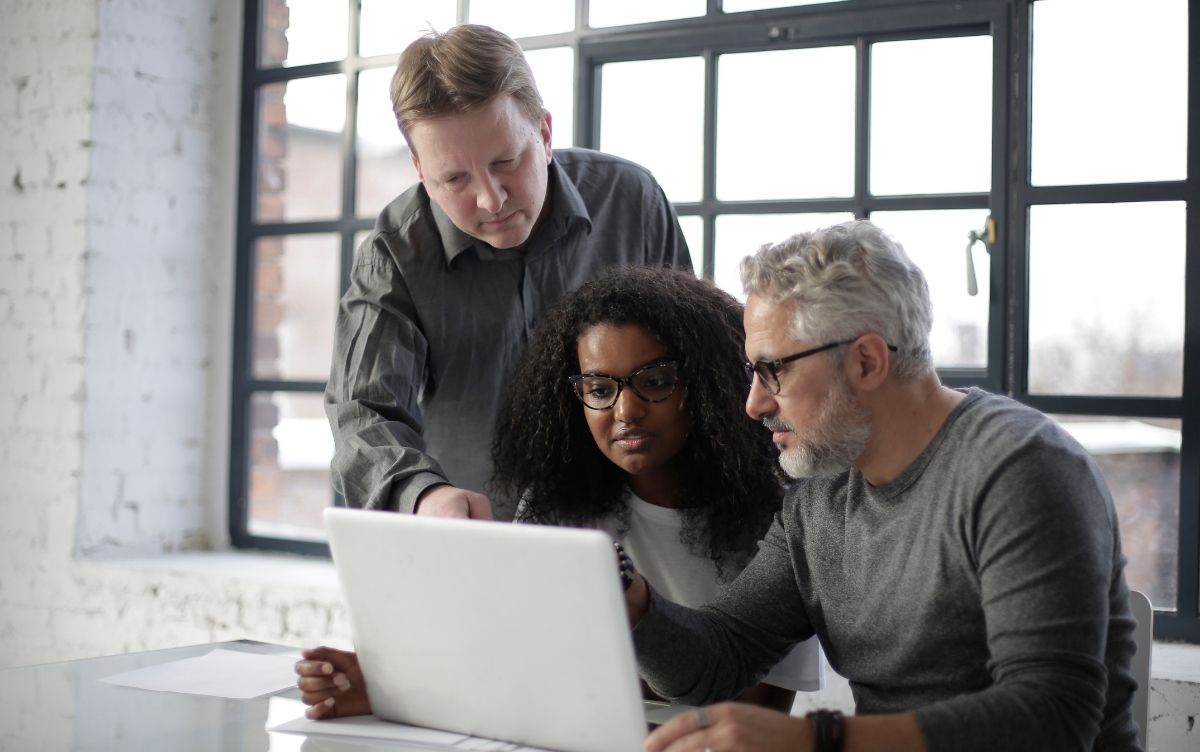 Group of people looking at a laptop